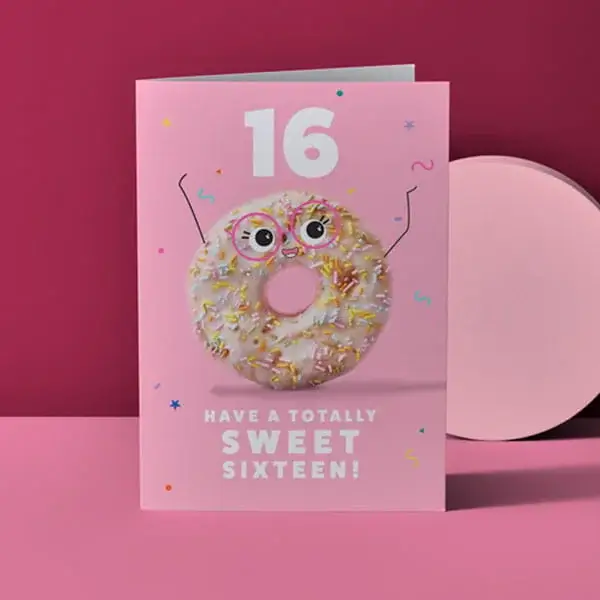 Pink 16th birthday card featuring a sprinkle-covered doughnut character and Sweet Sixteen message on a pink background.